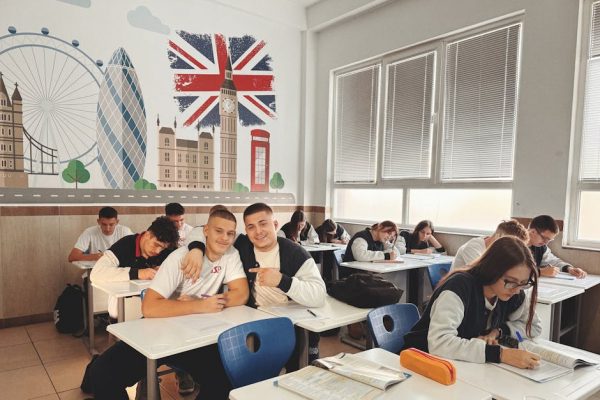 pexels-photo-29242208-29242208 Students studying in a classroom featuring a mural of London landmarks and British flag.